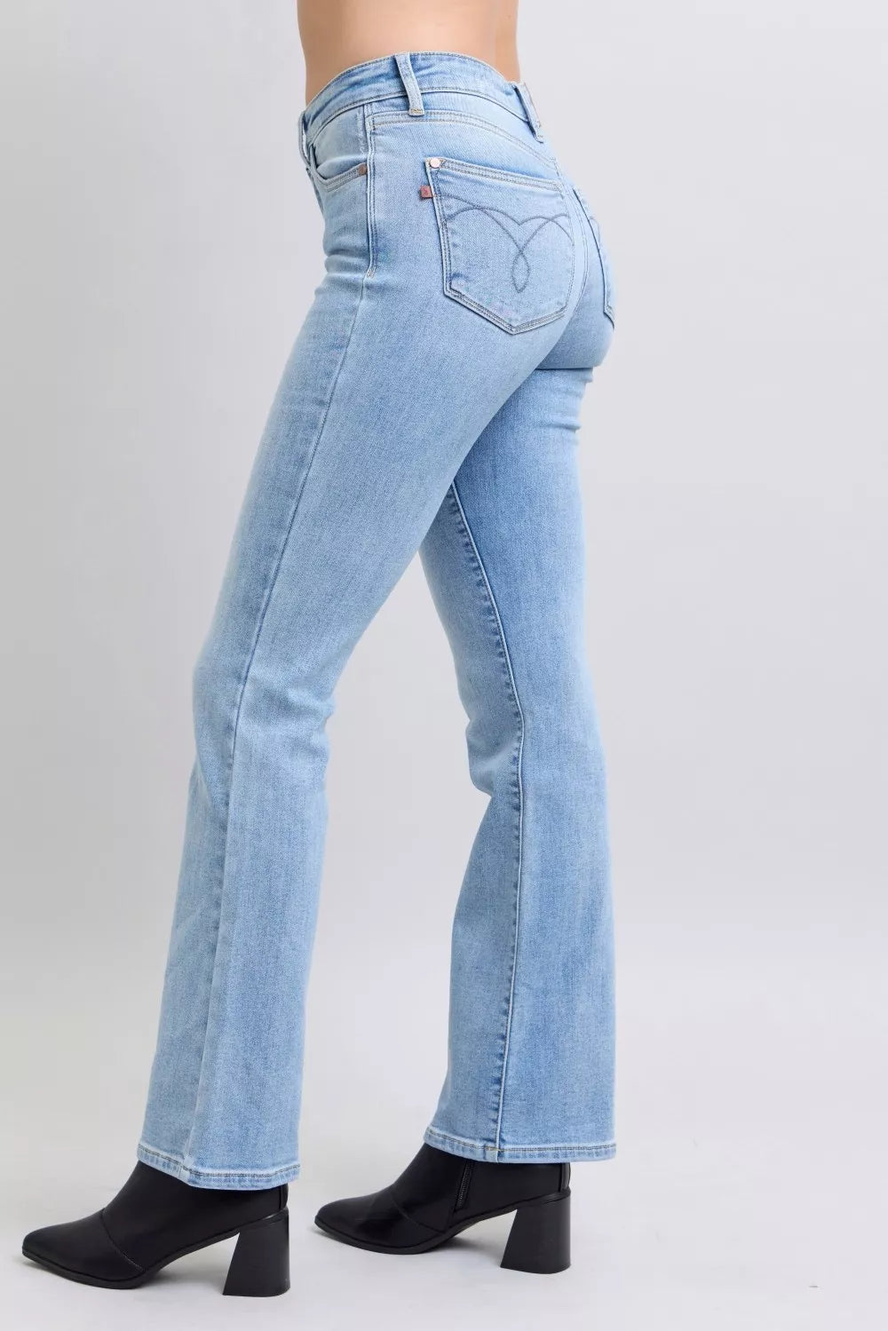 Back view light wash mid-rise bootcut jeans with patch pocket and stitched seams