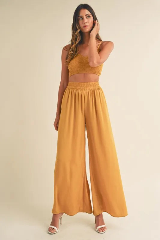 Gold mustard smocked bralette crop top and wide-leg pants with elastic waist