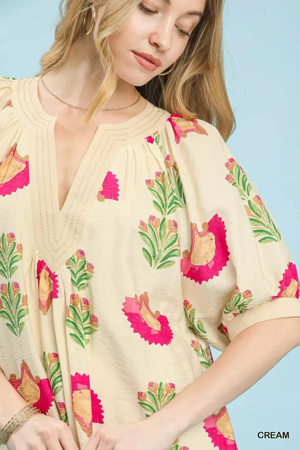 Cream V-neck mini dress with pink bird and green leaf print, dolman sleeves