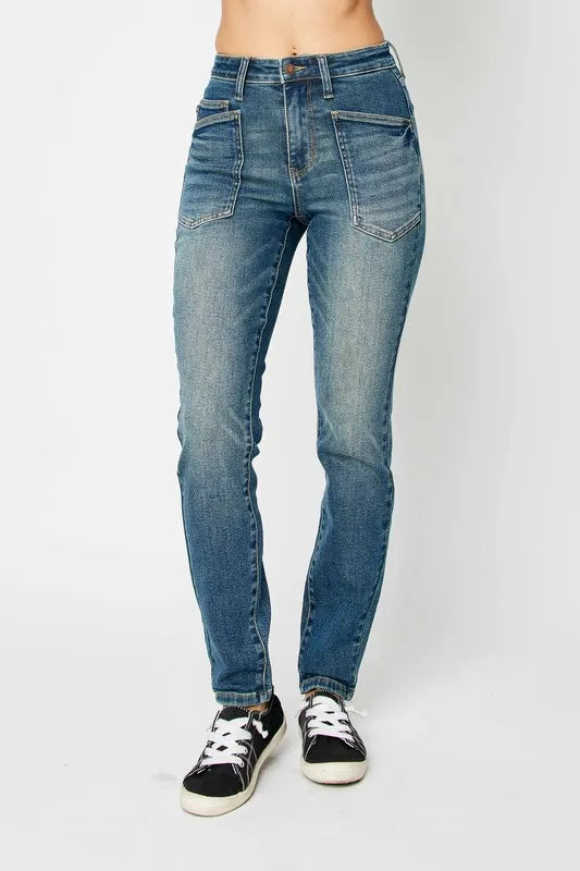 Dark high-waist skinny jeans with belt loops, zip fly, and front pockets