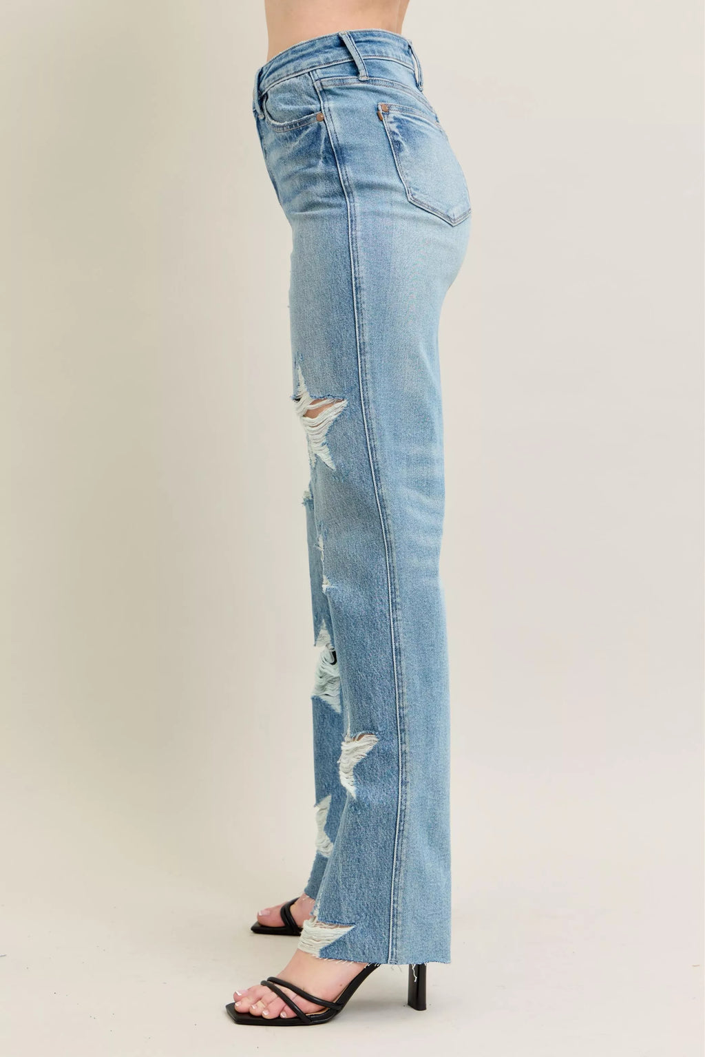 Side view: high-waist straight light wash jeans with star-shaped distressed rips