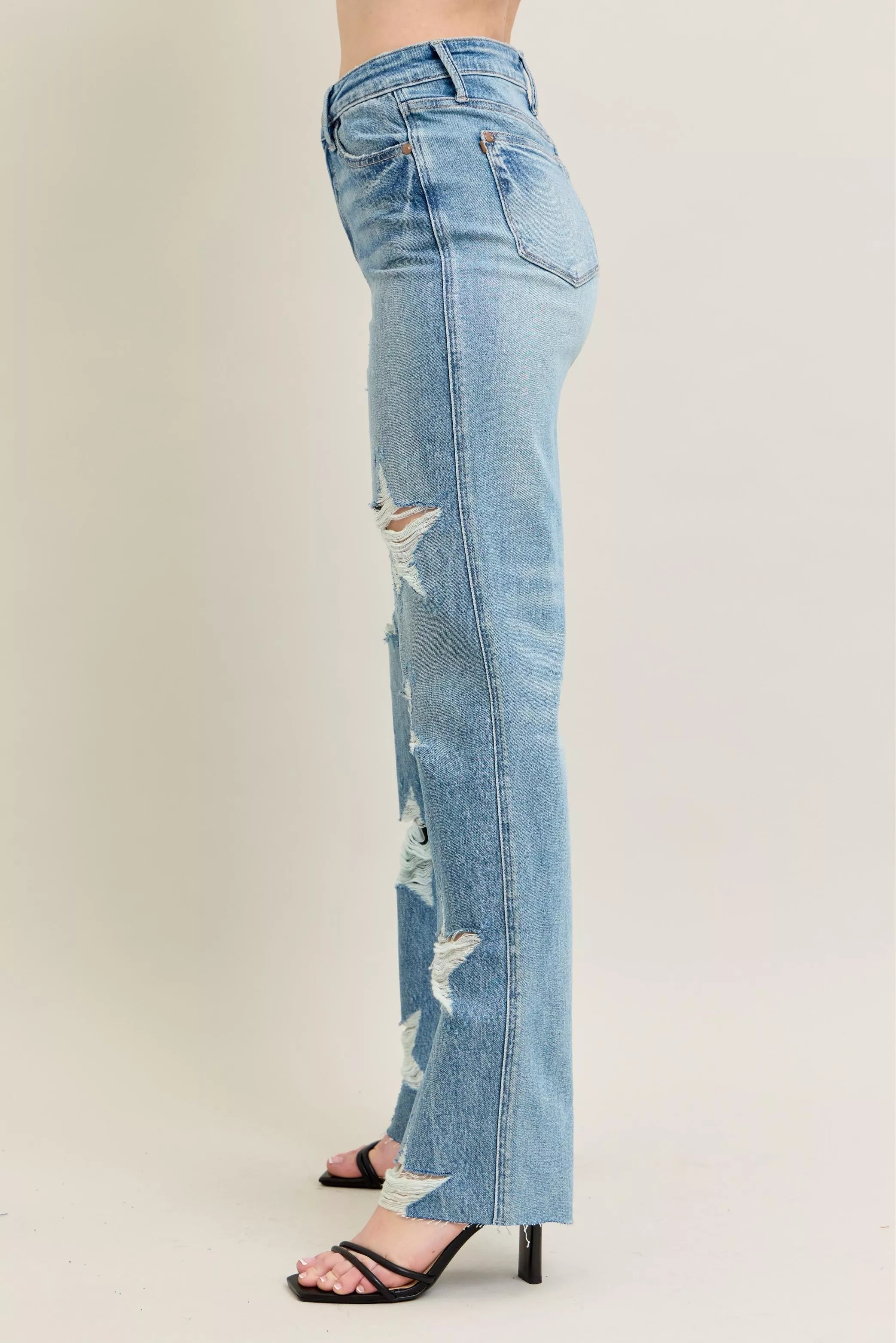 Side view: high-waist straight light wash jeans with star-shaped distressed rips