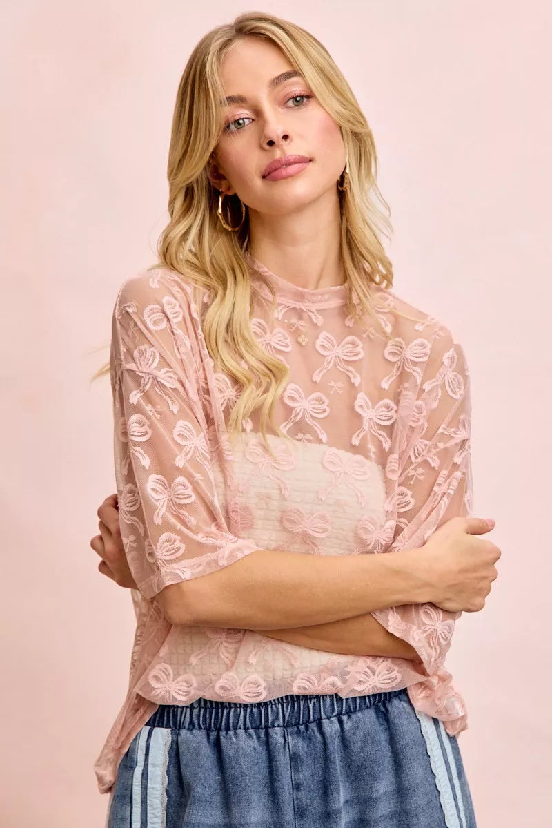 Dusty rose bow print mesh top with crew neck and short sleeves, boxy style