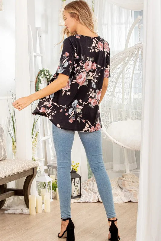 Black floral babydoll top back view with curved hem and short sleeves