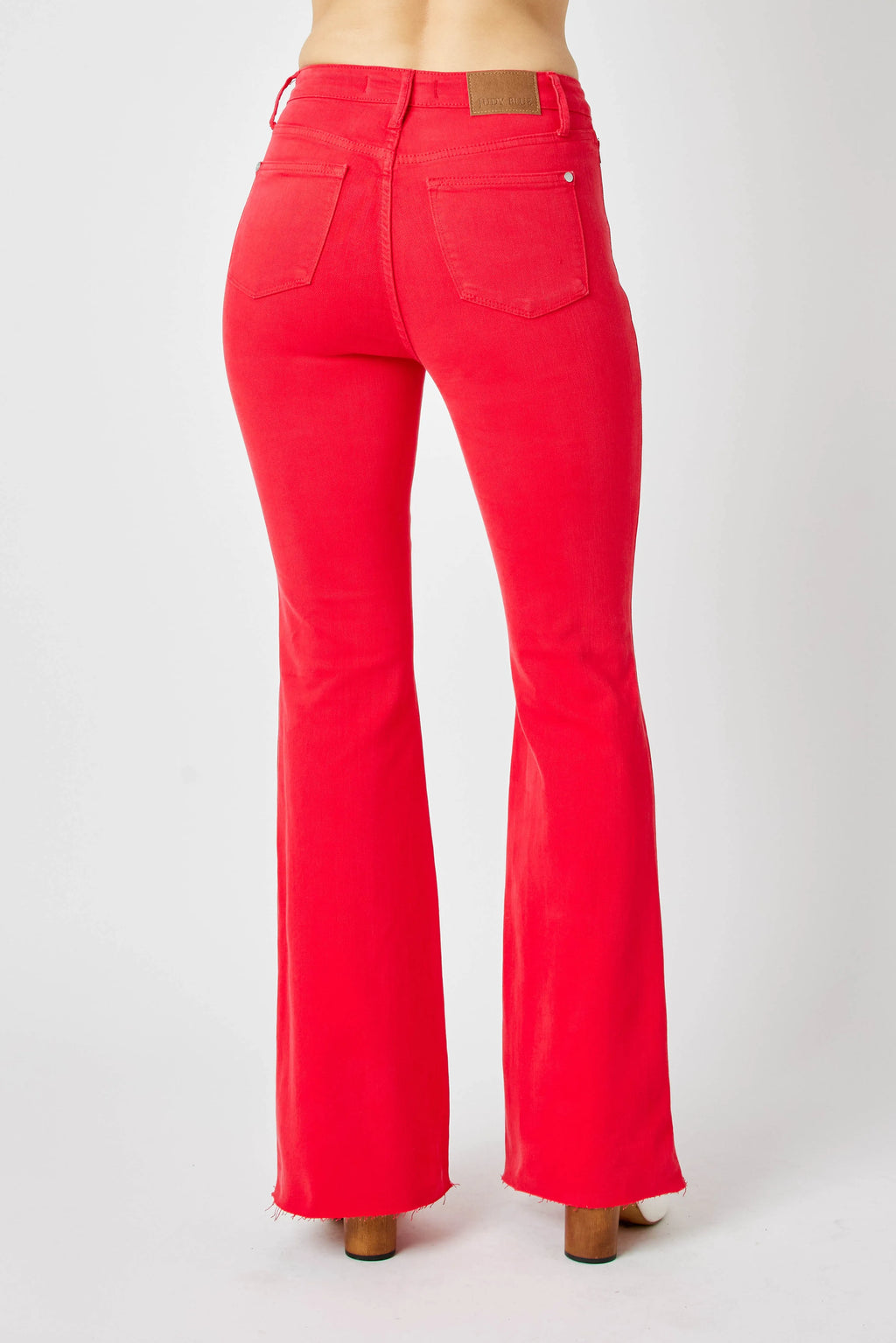 Red flare jeans, centered back view with rear pockets and flared straight legs