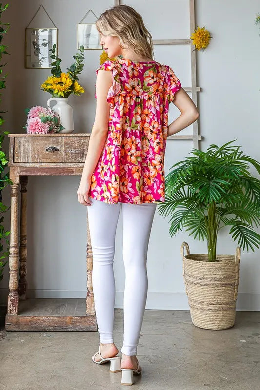 Back view: fuchsia floral tiered top with butterfly sleeves and gathered yoke