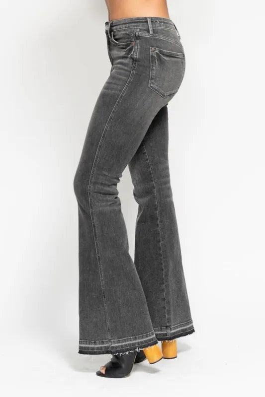 Washed gray mid-rise flare jeans, side view with frayed release hem and front pockets