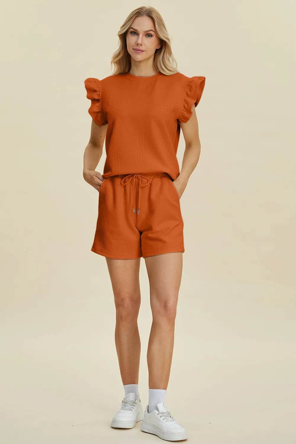 Orange knit set: ruffle cap sleeves, textured fabric, drawstring waist shorts