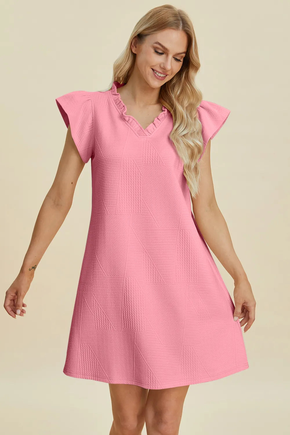 Pink ruffled V-neck cap-sleeve dress with textured pattern and flared skirt