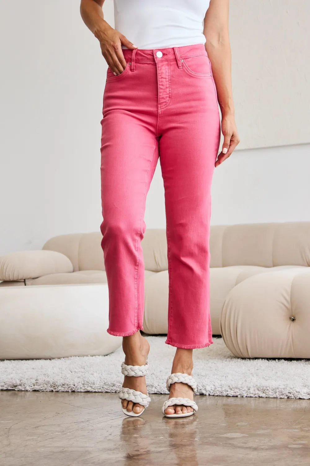 Sunkissed pink high-waist jeans, straight fit, raw hem detail at cuffs