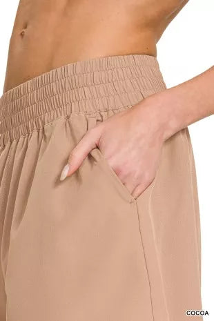Cocoa shorts close-up: smocked elastic waistband and front pocket seam
