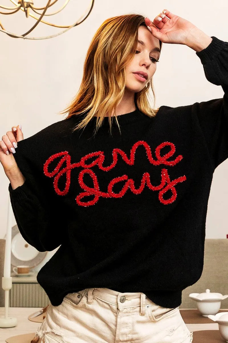 Black sweater with red “Game Day” lettering, wide cuffs and crew neckline