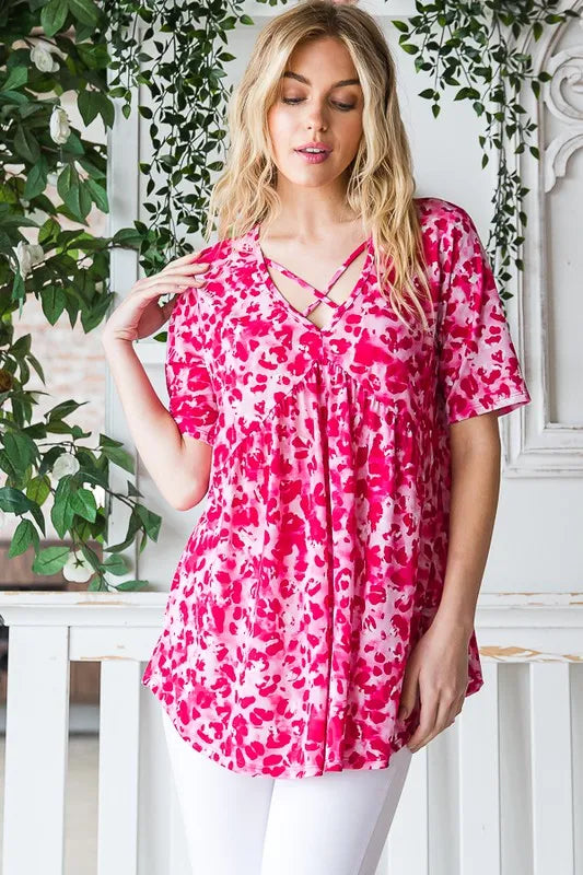 Hot pink animal-print babydoll tunic with crisscross neckline and pleated hem