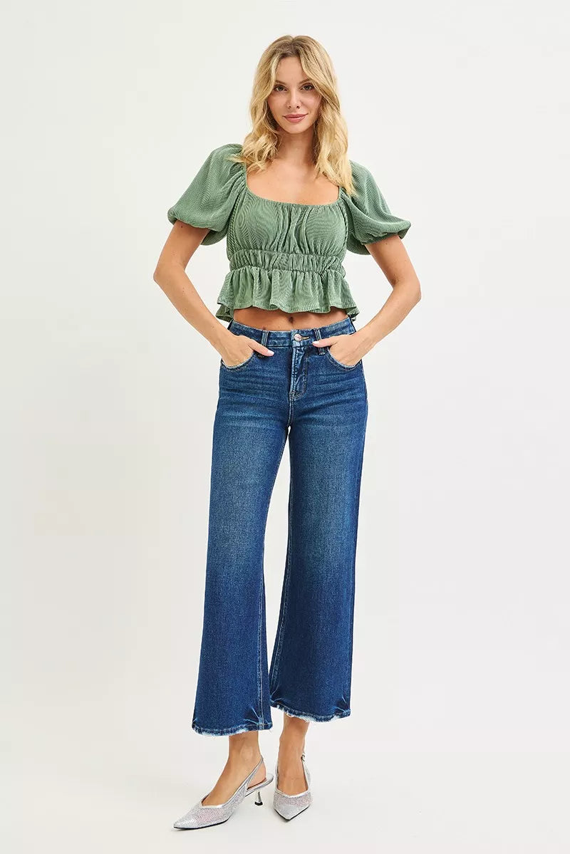 High-rise wide-leg crop jeans in dark wash, full-body front view with frayed hems