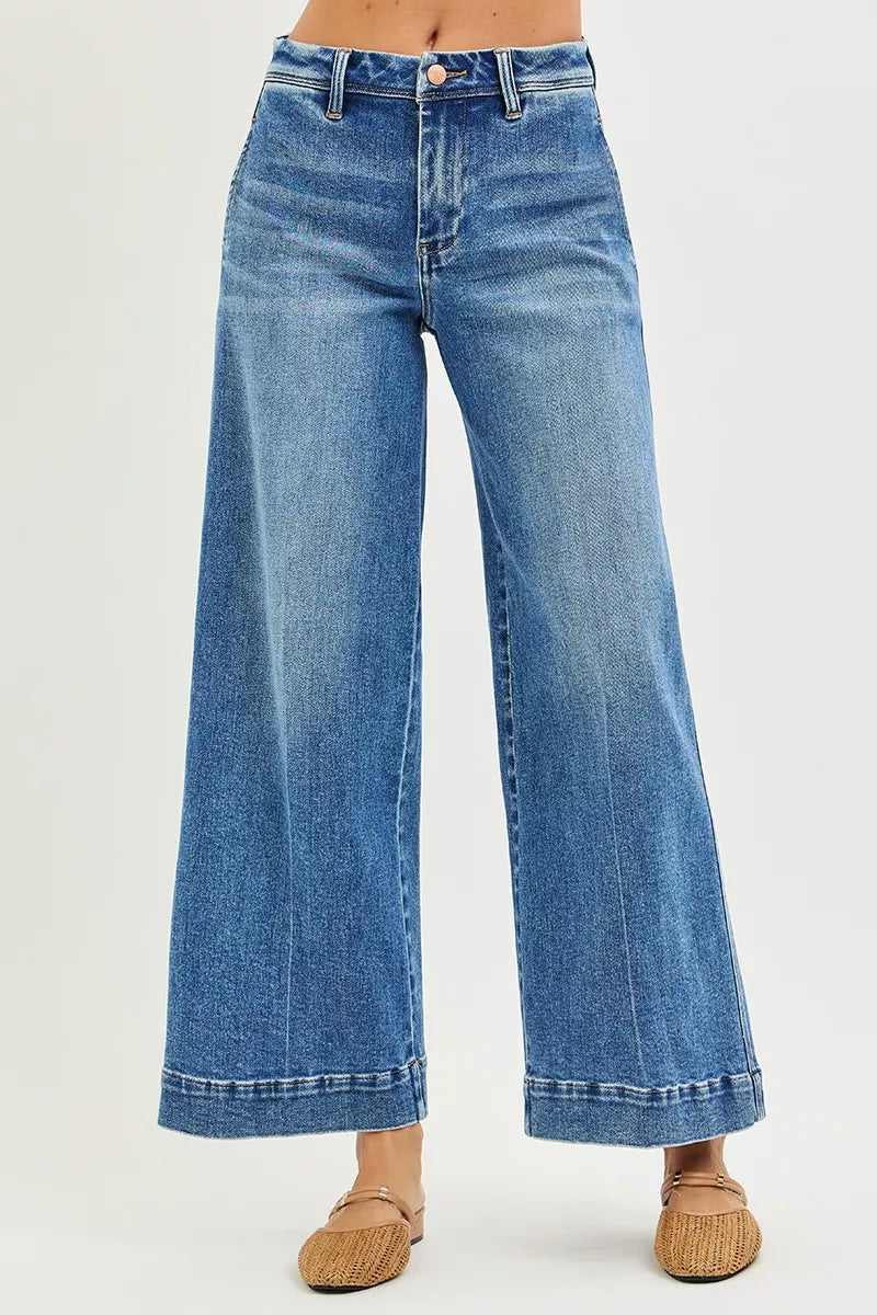 Slouchy wide-leg jeans front view, dark blue denim with button-fly and cuffed hem