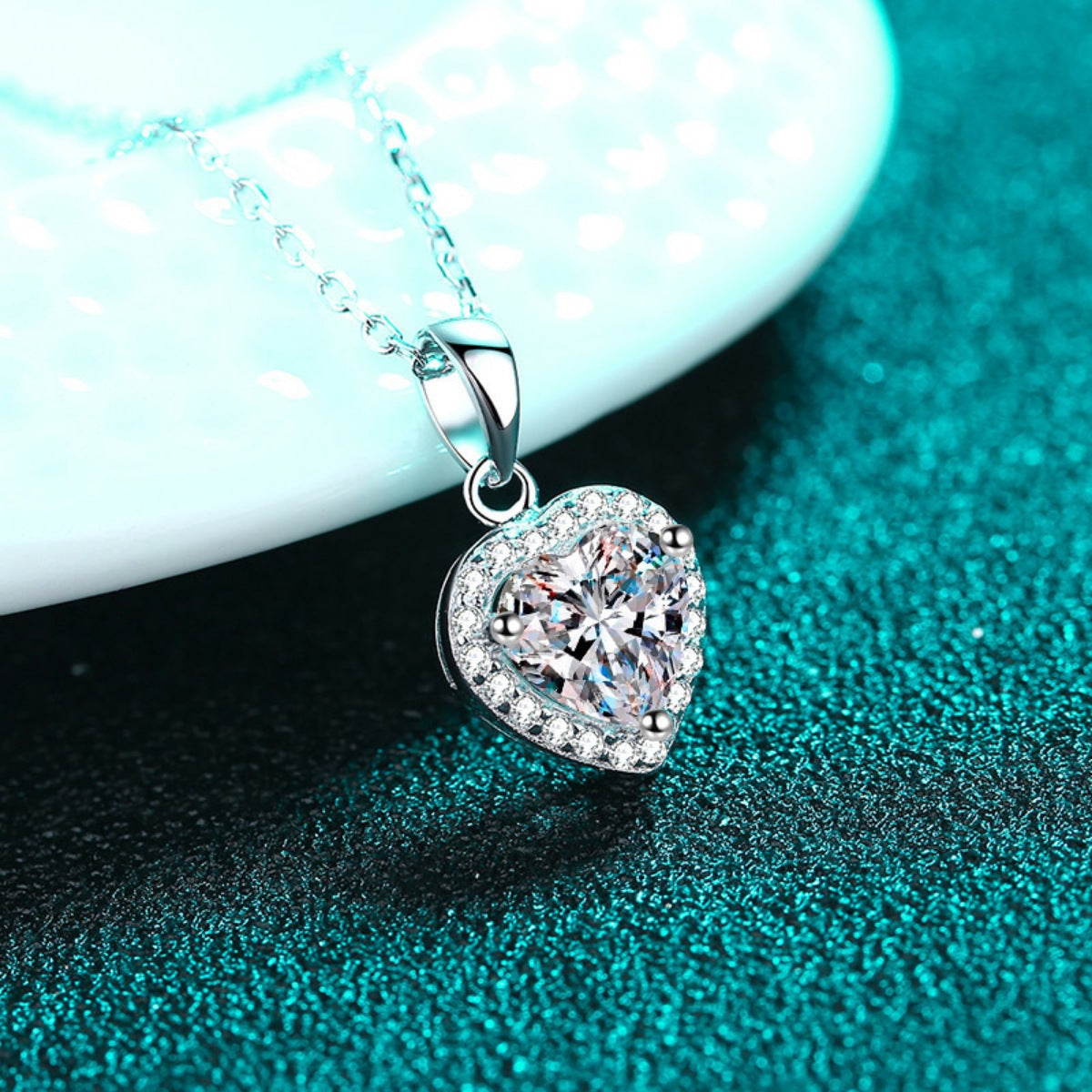 Heart-shaped pendant with sparkling halo stones on a silver necklace chain