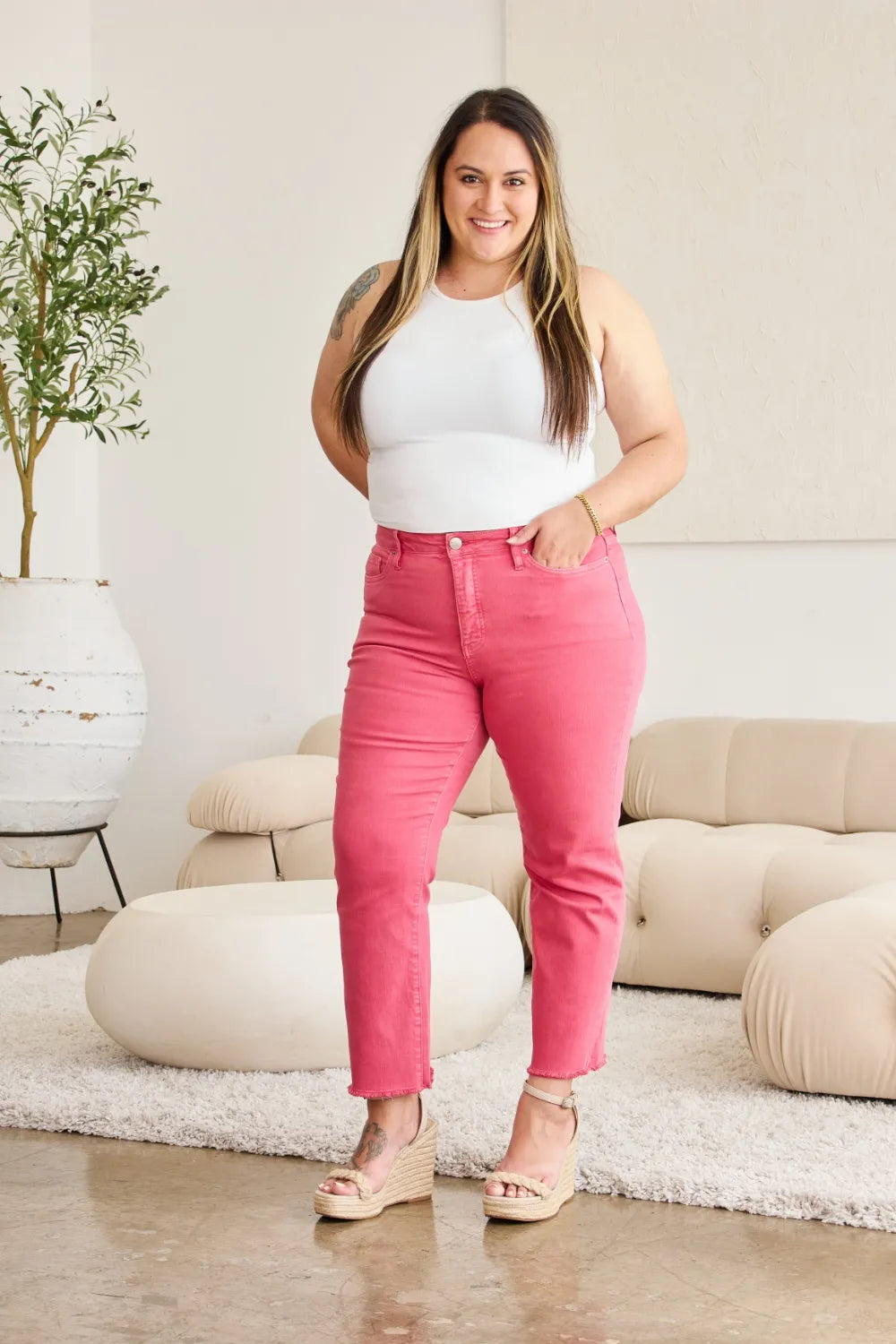 Sunkissed pink high-rise jeans with straight leg fit and raw cuff hem