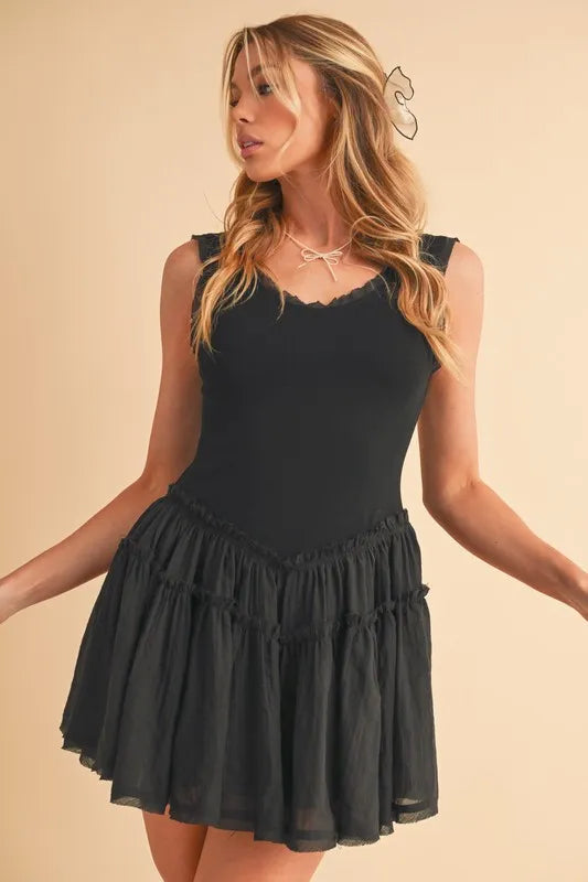 Black sleeveless mini dress with tiered, ruched drop-waist skirt