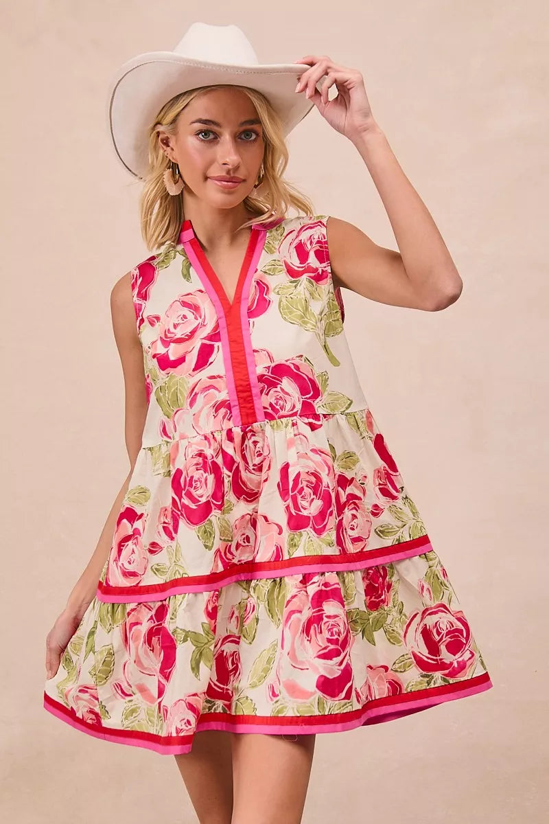 Coral rose-pattern mini dress with bright pink piping, sleeveless V-neck tiers