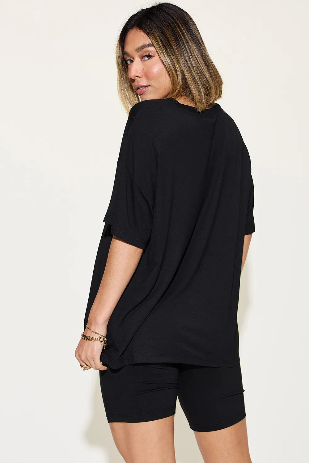 Black T-shirt and shorts set, side view with V-neck and relaxed fit