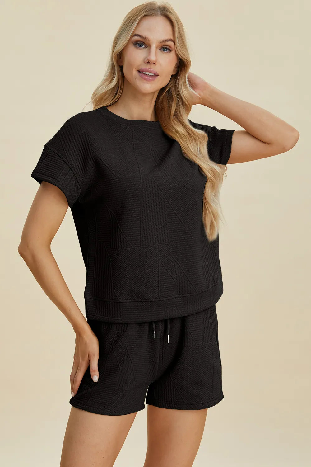 Black textured short-sleeve top and drawstring shorts set, relaxed fit.
