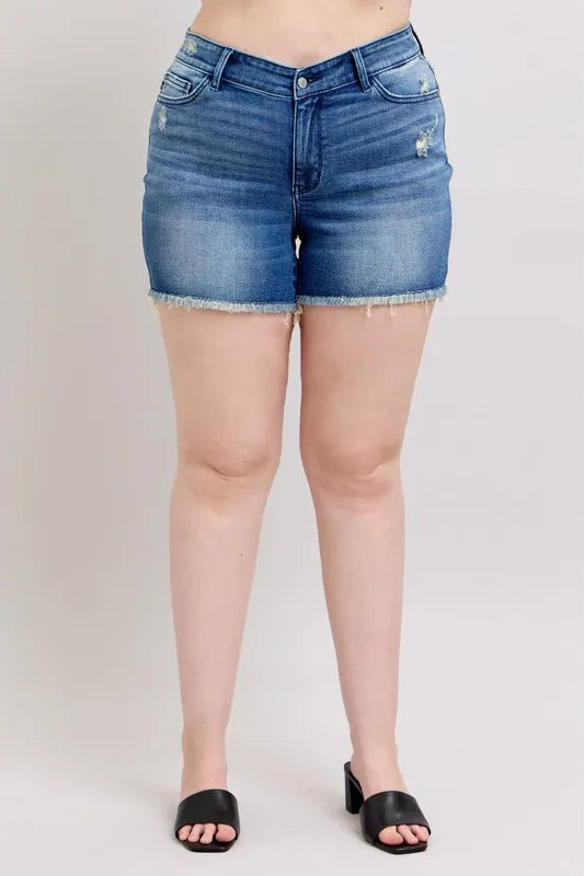 Blue denim shorts with frayed hem, button fly, and shield-style front pockets
