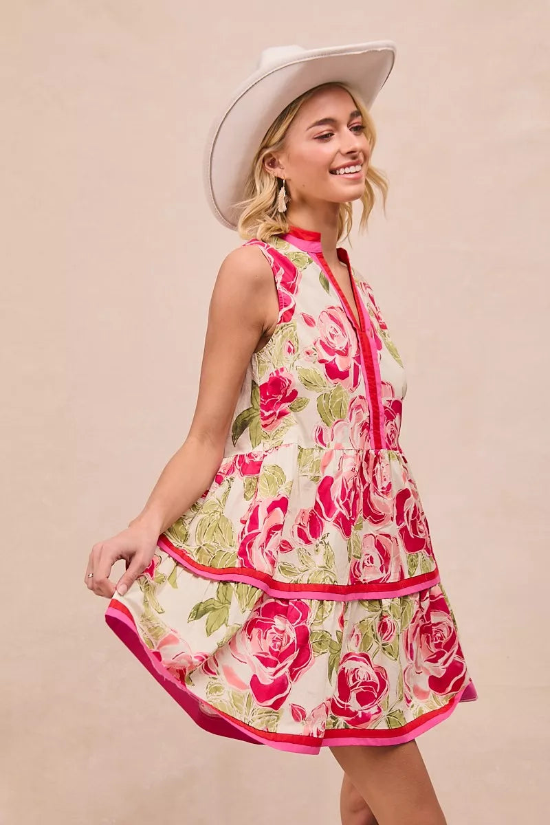 Coral rose-print sleeveless mini dress with pink contrast trim and tiered skirt