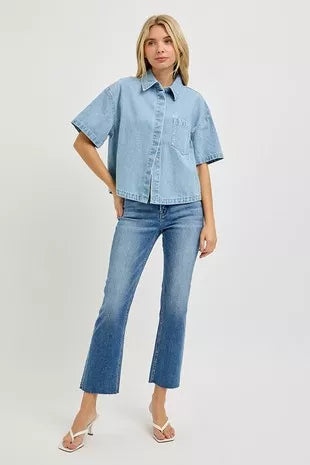 Light-wash oversized cropped denim shirt with half sleeves, worn with slim jeans