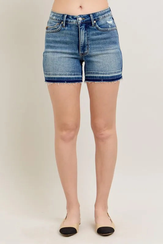 Back view: vintage wash denim shorts with frayed hem, patch pockets and belt loops