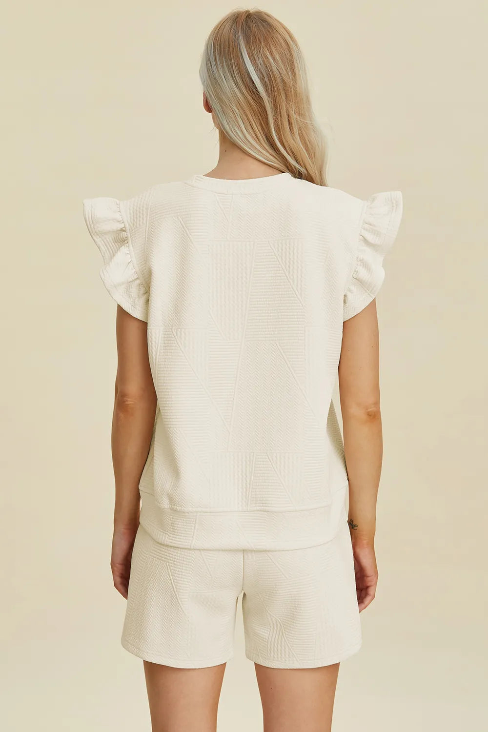Cream textured back view: ruffle sleeves top and matching shorts