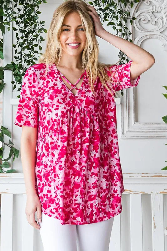 Pink animal-print babydoll top with crisscross neckline and gathered skirt