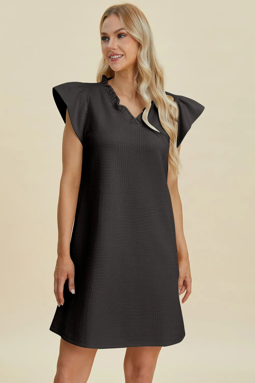 Ruffled V-neck cap sleeve dress in black with ruffled sleeves and textured pattern detail.