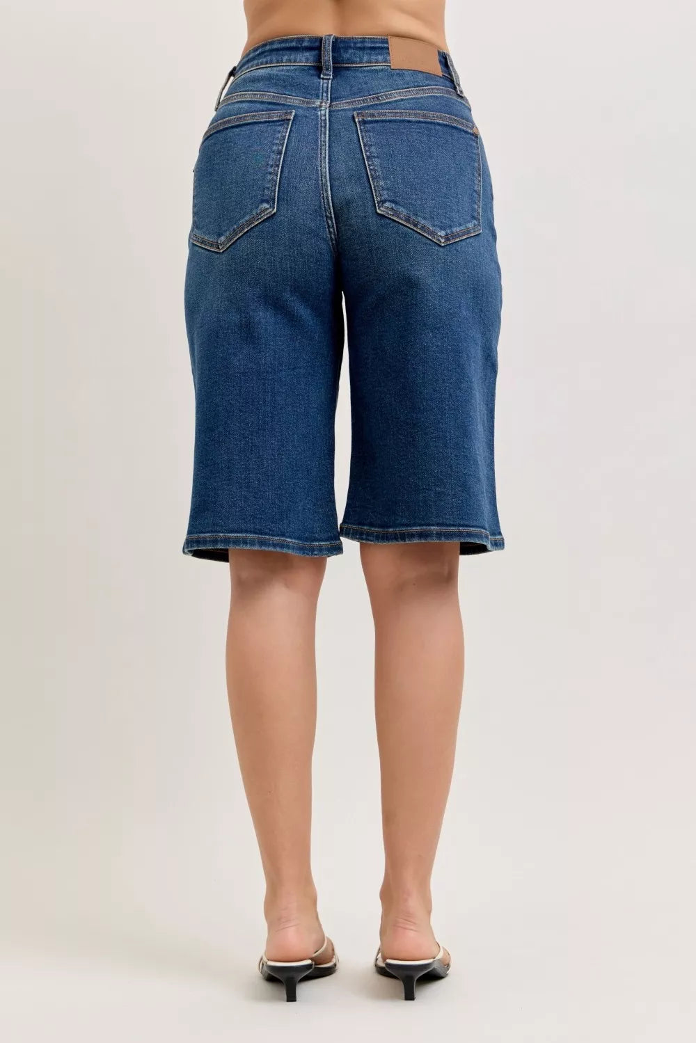 High-waist denim bermuda shorts, dark DK wash, back view with two patch pockets