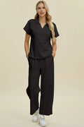 Black short-sleeve collared top and wide-leg pants set with drawstring waist