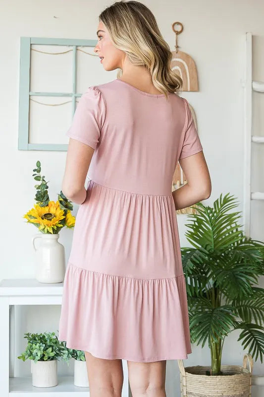 Back view dusty rose tiered mini dress with elastic neckline and lace-trim waist