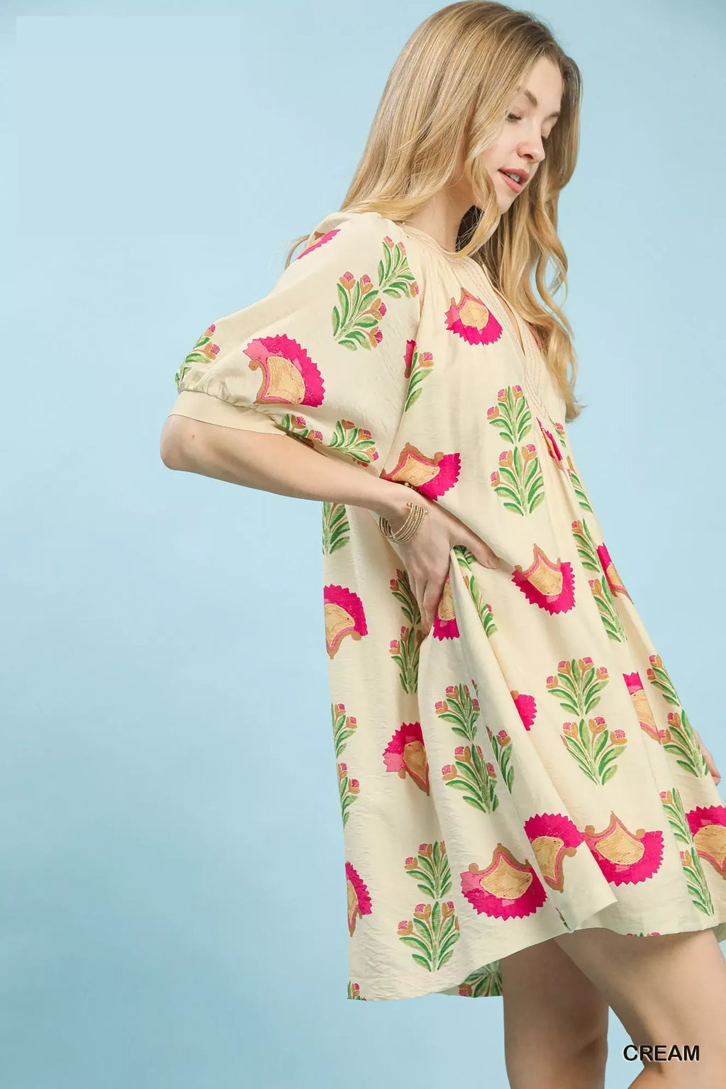 Cream mini dress with balloon sleeves and pink bird print, side view