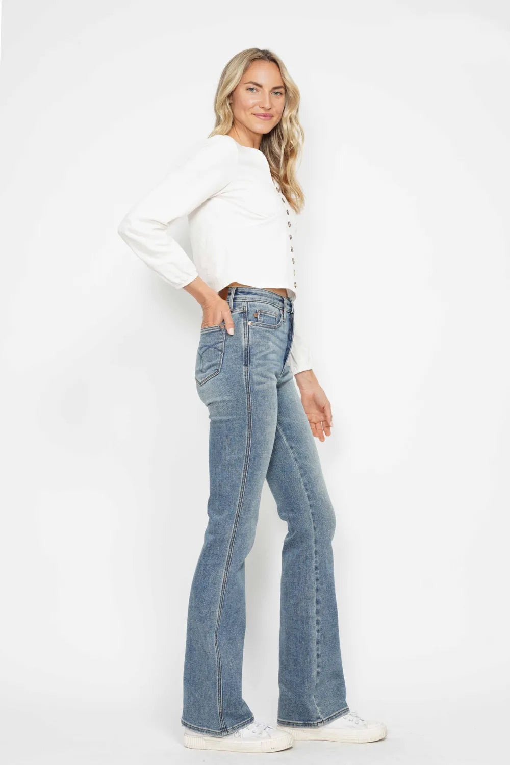 Light blue bootcut jeans with belt loops, button-zip fly, and stitched pockets