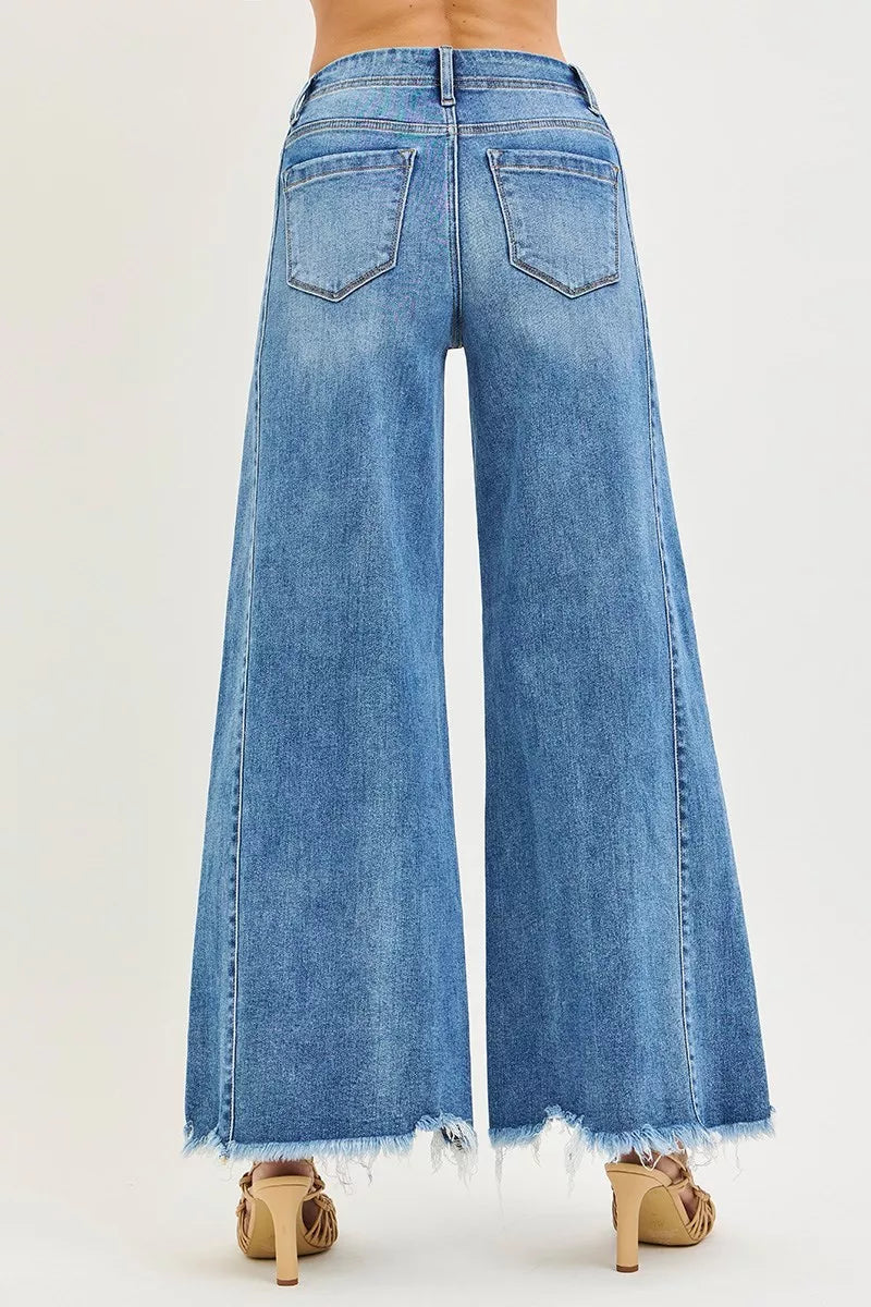 High-rise wide-leg jeans in medium wash with back patch pockets and frayed hem