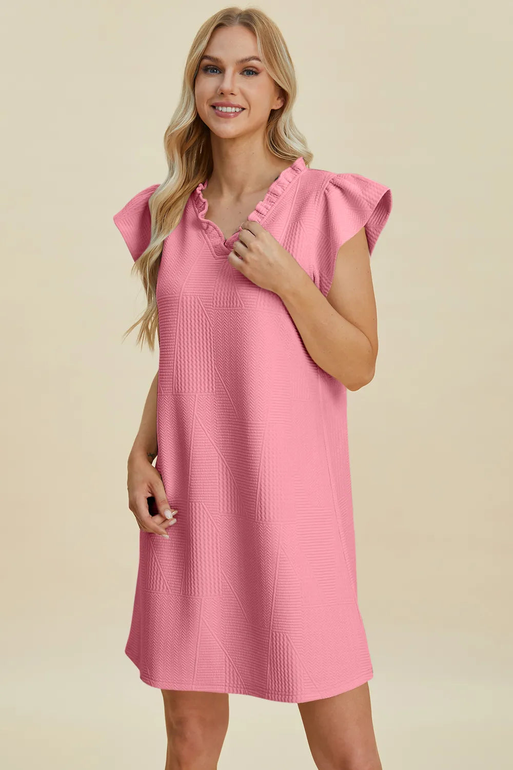 Pink ruffled V-neck cap-sleeve dress with textured pattern and ruffle trim