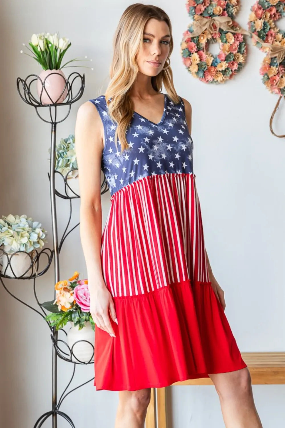 Sleeveless tank dress close-up: blue star yoke with red striped midsection and flare hem