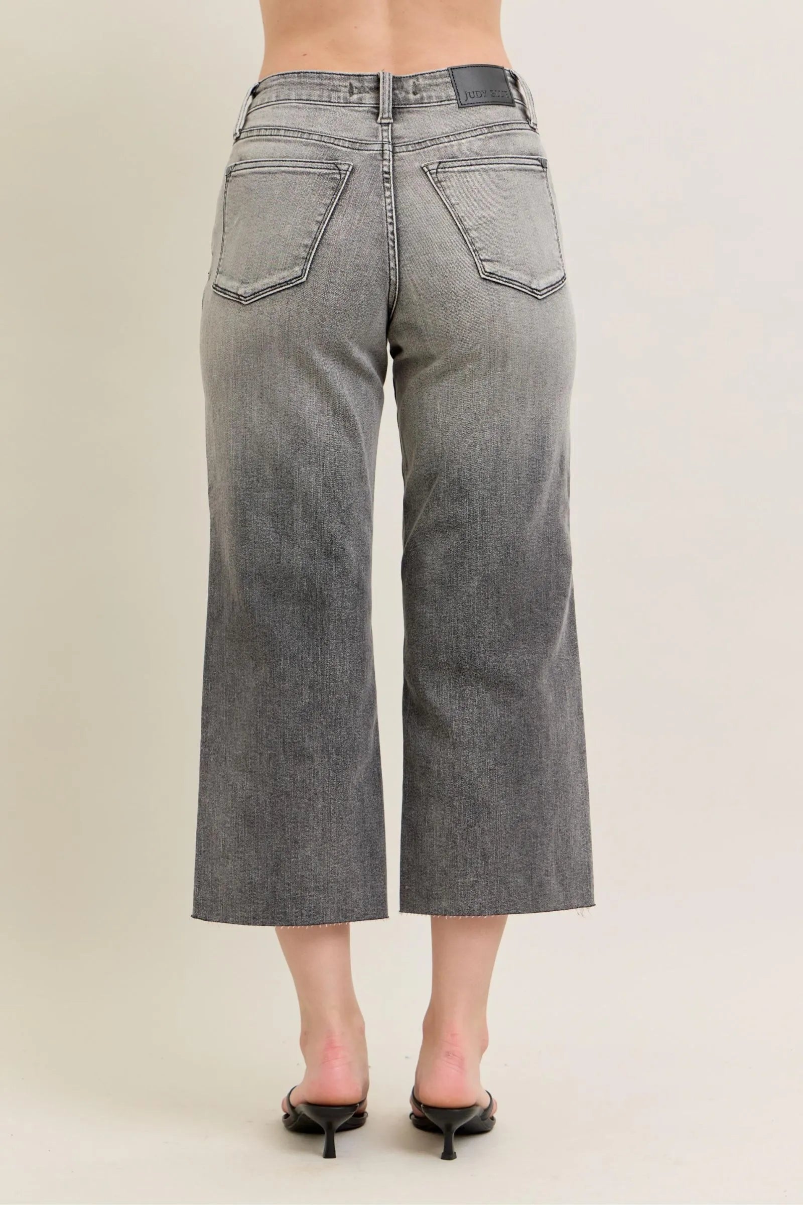 Gray wide-leg capri jeans, back view with two large patch pockets, belt loops