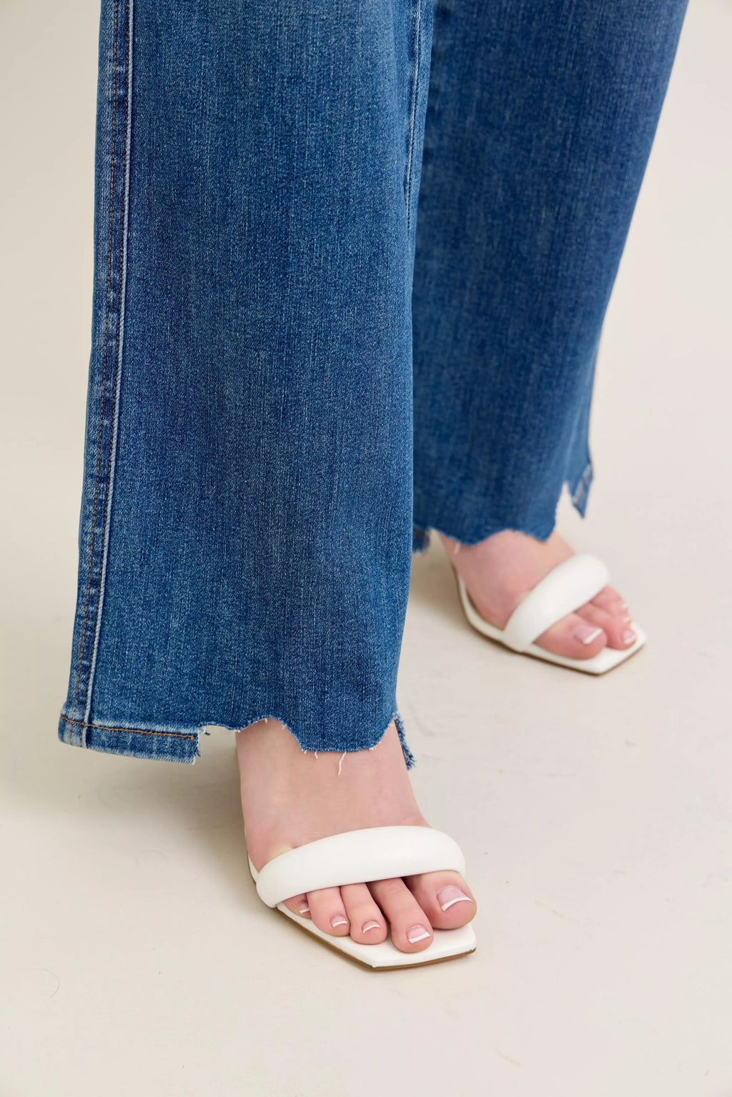 Wide-leg denim with distressed side slit and frayed, uneven hem