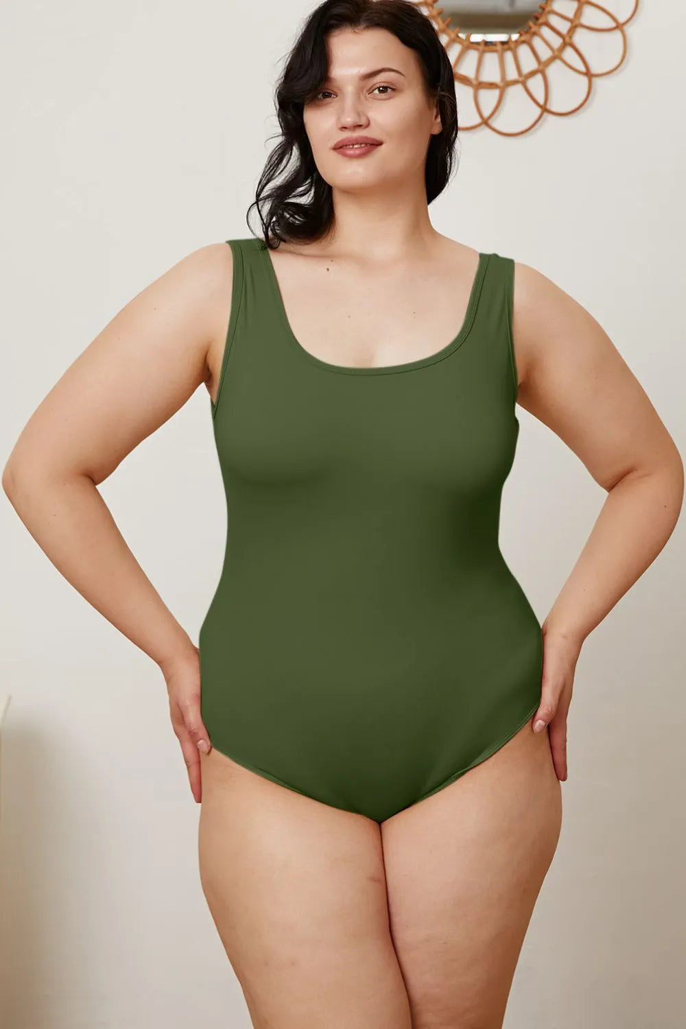 Dark green sleeveless bodysuit with scoop neckline, front view
