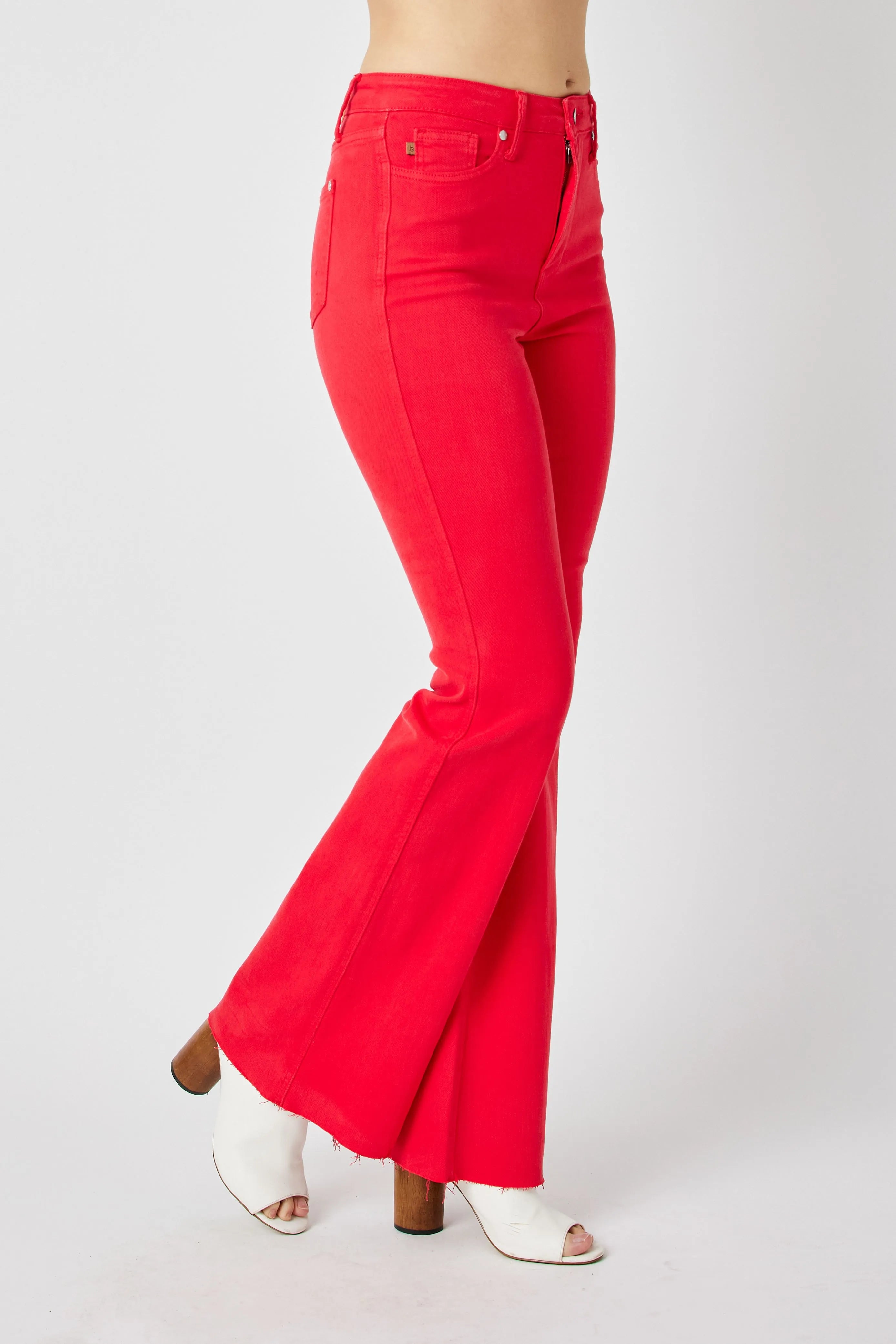 Red high-rise flare jeans, side back view with stitched seams and wide leg opening