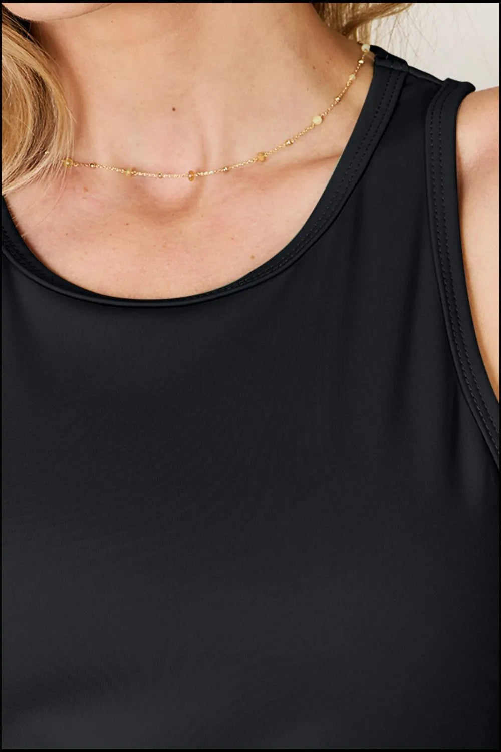 Black racerback tank top, round neckline and racerback straps
