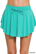 Turquoise tennis skirt with ruffle hem, elastic waist, and hidden inner pockets