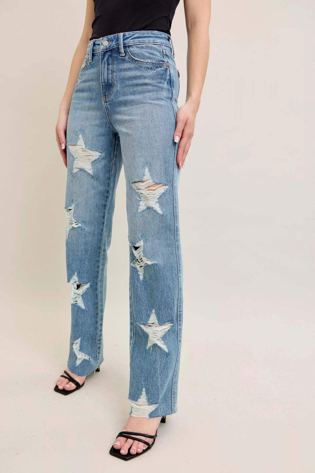 High-waist light denim straight jeans with scattered star-shaped distress
