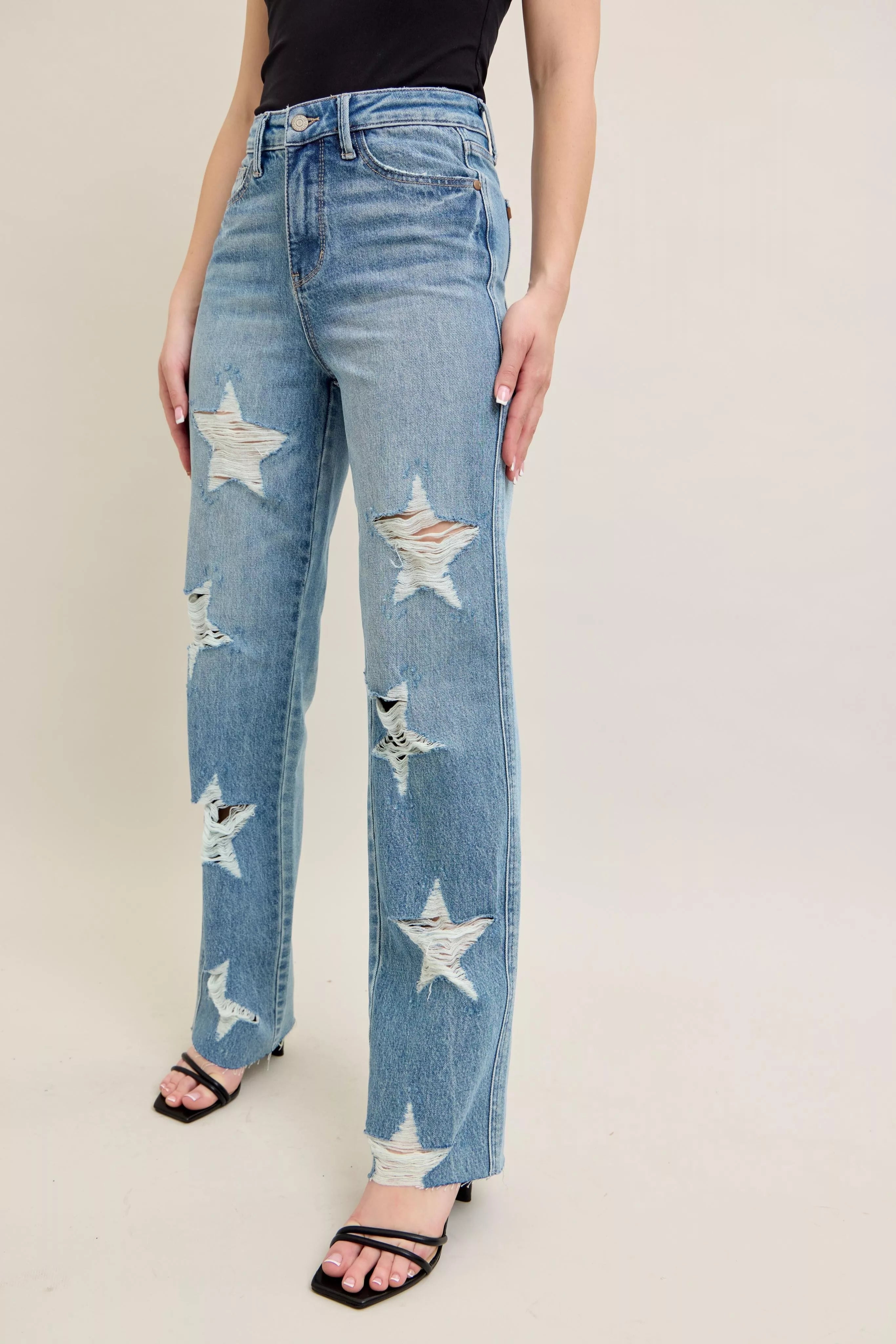 High-waist light denim straight jeans with scattered star-shaped distress