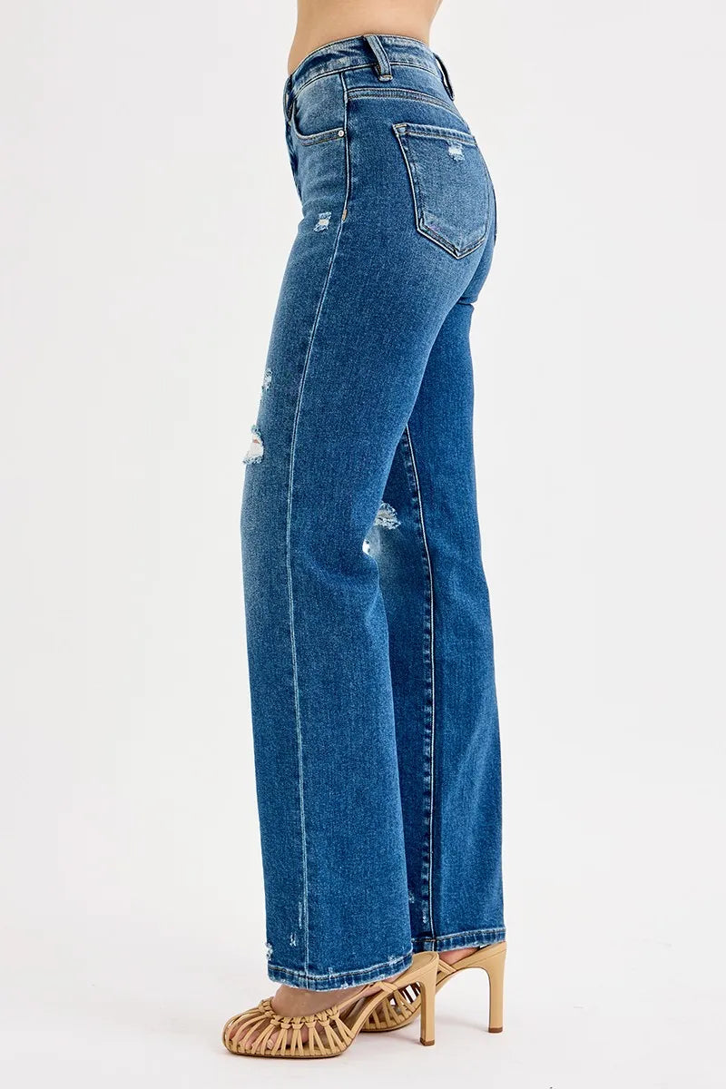 Dark high-rise straight jeans, side seam and back pocket, distressed spots along leg