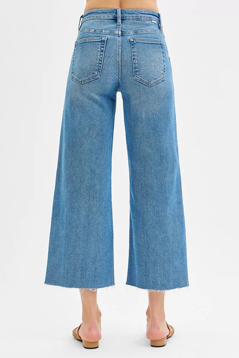 Medium-wash back view of wide-leg crop jeans with two back pockets
